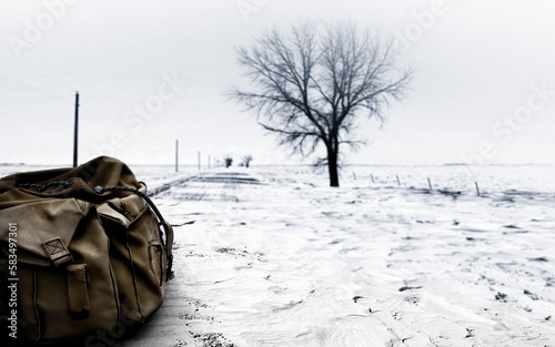 An abandoned backpack on a snowy road in Eastern Europe.