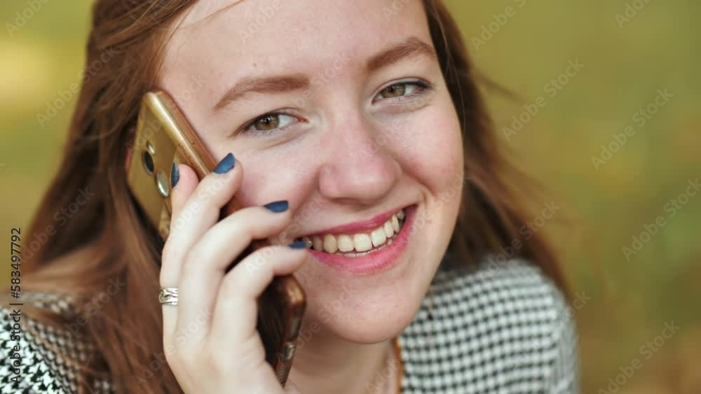 A young girl talking on the phone. Close-up of her face. A young girl talking on the phone. Close-up of her face.