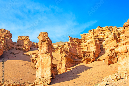 Charyn Canyon is a canyon on the Sharyn River in Kazakhstan, east of Almaty. Landscape on a clear sunny day in summer, there are many clouds in the sky.