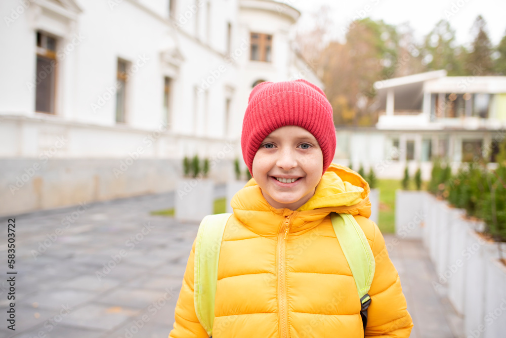 portrait of a happy schoolboy in a jacket with a backpack going to school in autumn portrait of a happy schoolboy in a jacket with a backpack going to school in autumn