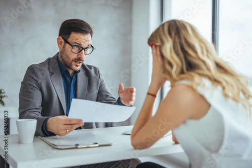 Fotografie Mad male worker yelling at female colleague asking her to leave office, multirac