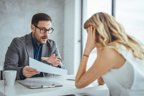 Angry businesswoman dissatisfied by contract conditions, arguing with business partner, contractor at meeting, woman pointing at document, blaming man, defrauded cheated investor, failed deal