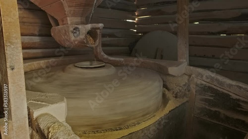 Working old water powered grist mill made of stones and wood, 4k