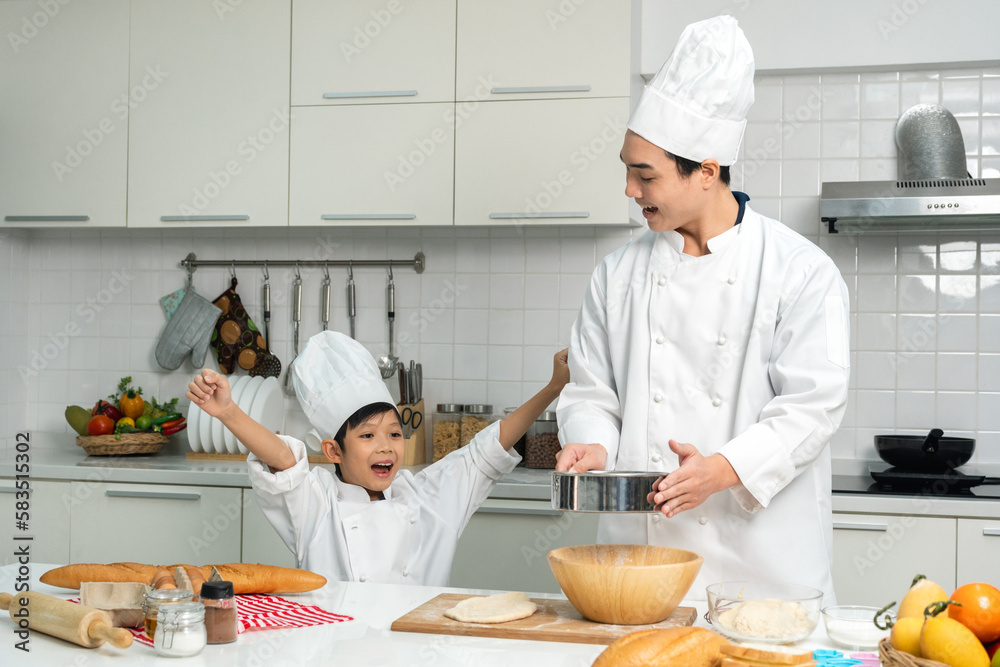 Young handsome asian man chef cooking breakfast in the kitchen. Happy asian man preparing food with ingredient. Chef in uniform in the kitchen. Young handsome asian man chef cooking breakfast in the kitchen. Happy asian man preparing food with ingredient. Chef in uniform in the kitchen.