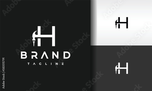 letter H hammer nail logo