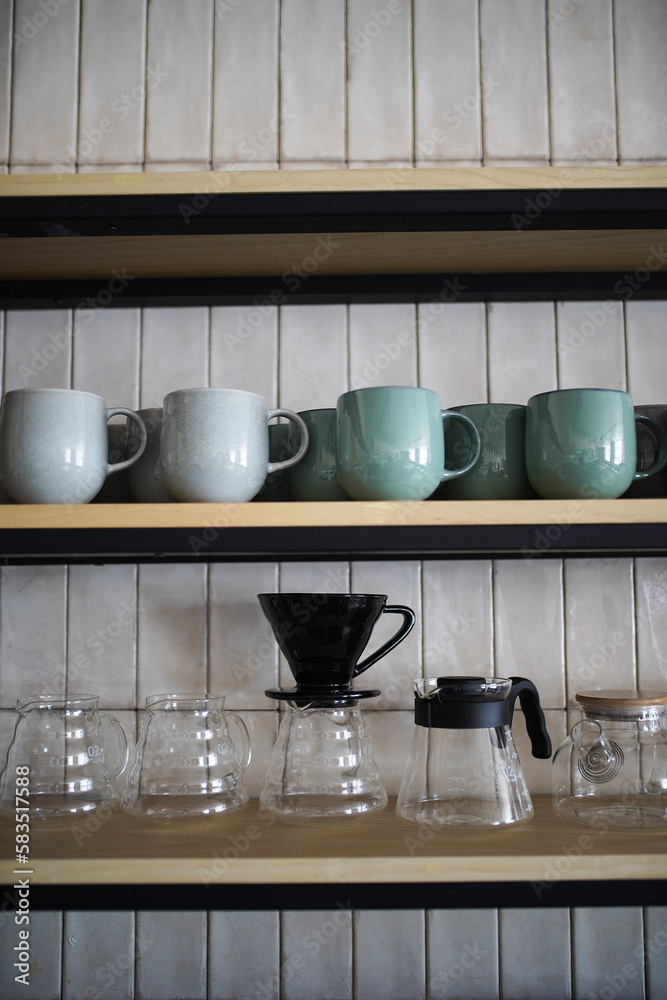 Kitchen shelves with various ceramic plates and glass cups