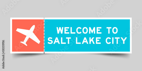 Orange and blue color ticket with plane icon and word welcome to salt lake city on gray background