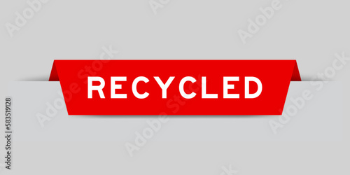 Red color inserted label with word recycled on gray background