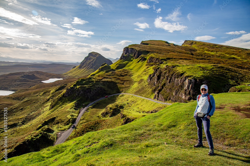 A woman walking in a Trail in The Quiraing