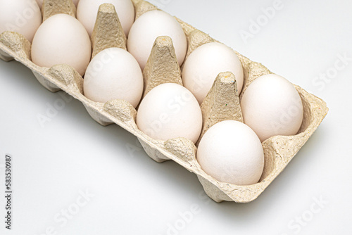 white chicken eggs are in the package