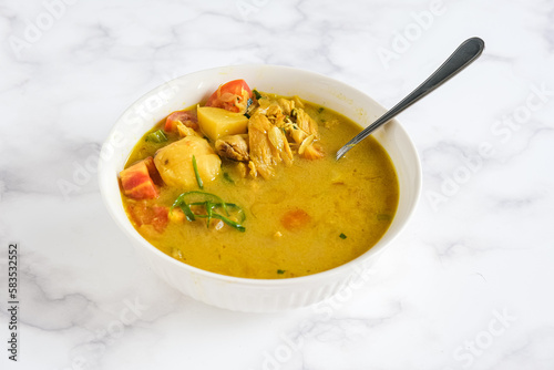 soto ayam, chicken soto is Indonesian traditional dish with yellow soup
 photo
