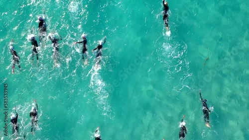 Aerial photo of a swimmers in open water swimming competition in turquoise sea photo