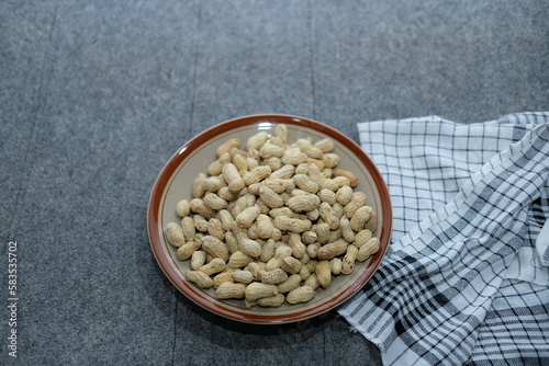 Roasted salted peanuts on a white plate