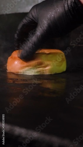 person toasting a bun