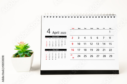 The April 2023 Monthly desk calendar for 2023 year with plant pot isolated on white background.