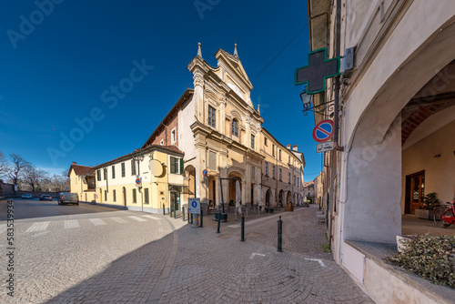Racconigi; Cuneo; Italy - Deconsecrated church of the confraternity of Santa Croce in Via Francesco Morosini and the arcades of the street