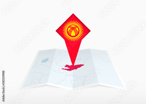 Kyrgyzstan is depicted on a folded paper map and pinned location marker with flag of Kyrgyzstan. photo