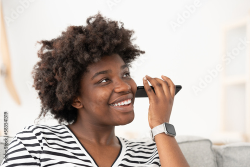 Fotografie African American young woman listening voicemail or voice message on phone