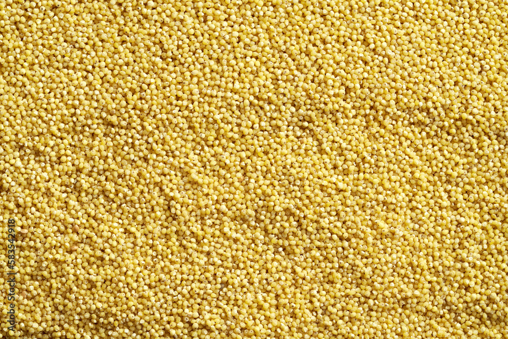 Yellow background made of peeled millet, with copy space Yellow background made of peeled millet, with copy space