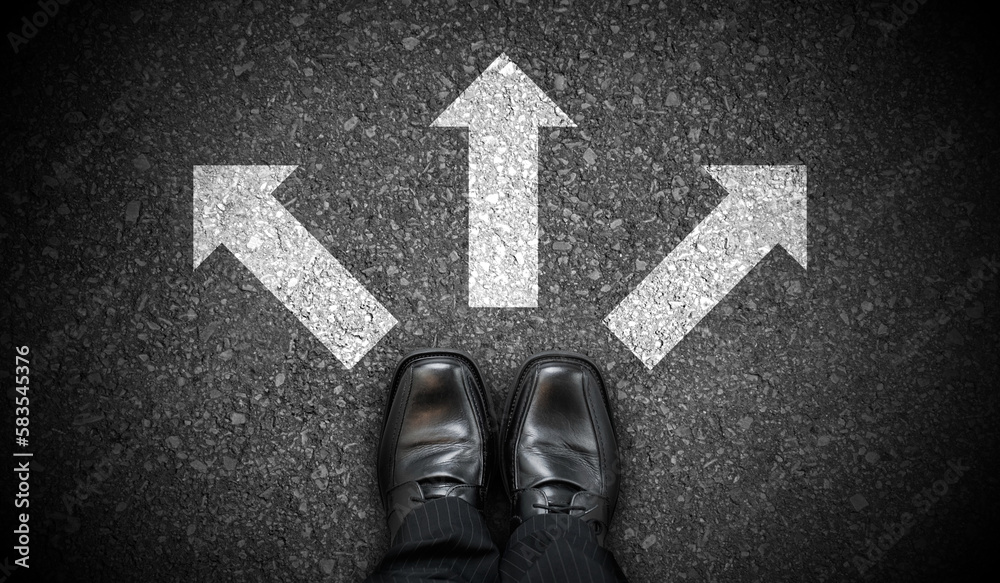 Fototapeta premium Black business shoes and three chalky arrows on asphalt - decision concept