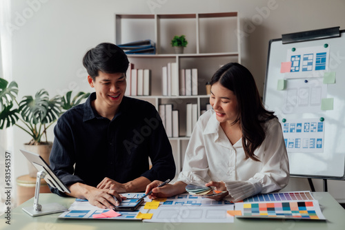 Man and woman ecommerce business workers using smartphone and Chart plan at the office.