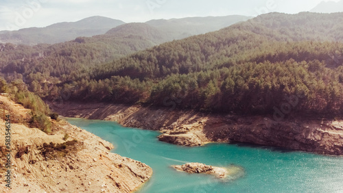 Aerial view of a beautiful canyon and a river with turquoise fresh water. Nature travel background. Reservoir on the Dimchay River from a bird's eye view.