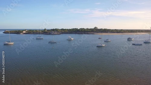 Aerial view of beautiful views of Ria Formosa park with sailboats and boats in the bay. Drone footage quatro aguas Tavira.
