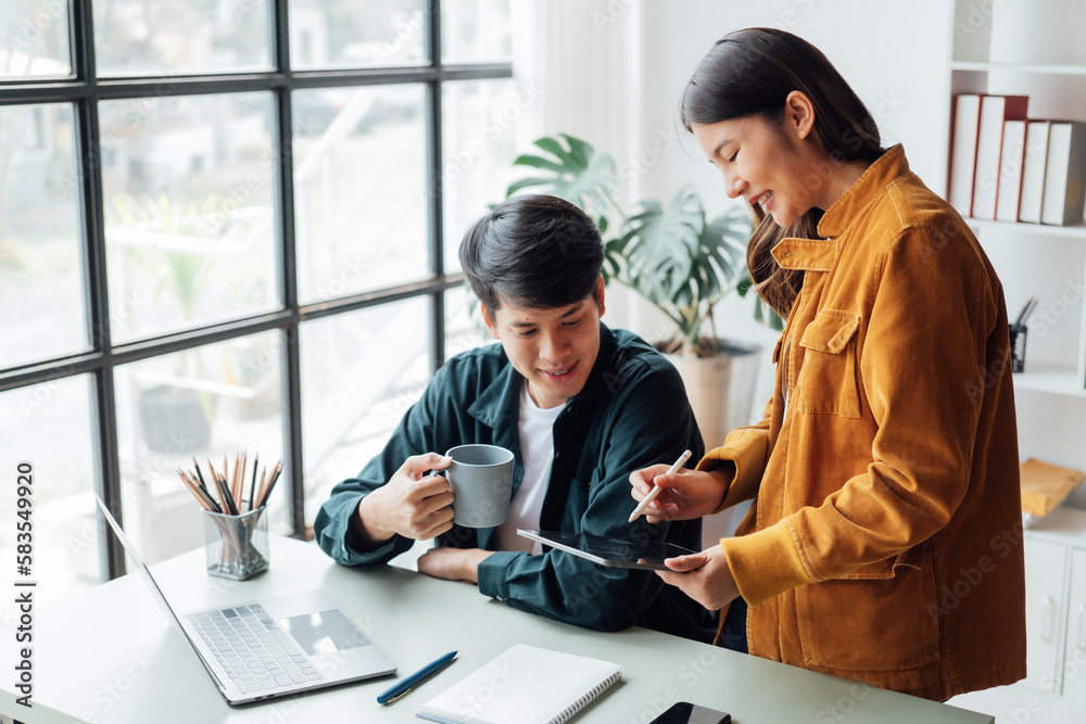 young husband and wife working at office by new project and happy. young husband and wife working at office by new project and happy.