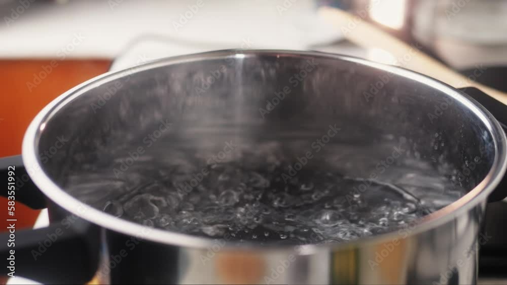Pot with boiling water on electric stove, space for text Pot with boiling water on electric stove, space for text
