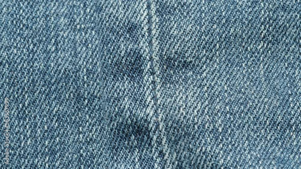 Blue jeans fabric close-up. Denim texture, abstract background. Tailoring industry and clothing concept, handmade sewing. Textile materials. Blue jeans fabric close-up. Denim texture, abstract background. Tailoring industry and clothing concept, handmade sewing. Textile materials.