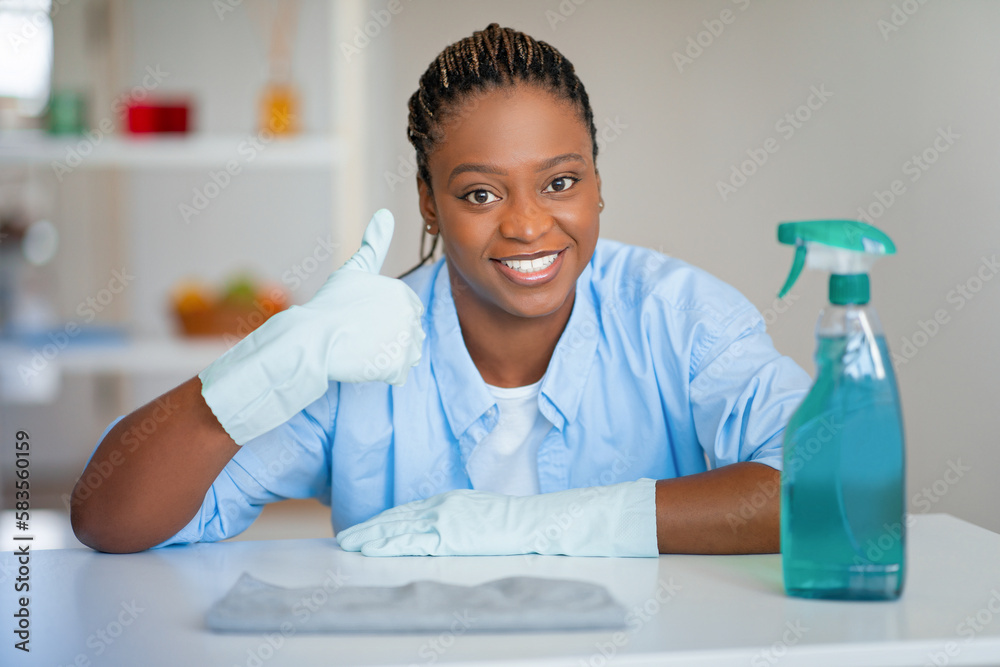Positive african american lady recommending nice furniture cleaner Positive african american lady recommending nice furniture cleaner