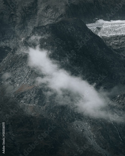 Vertical shot of floating clouds over the mountains in Austria near Grossglockner High Alpine Road