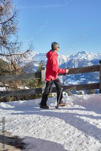 Vertical shot of the hiker in the Swiss Alps against a mountain background