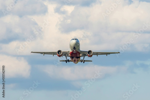 Takeoff of a jet passenger plane of the Rossiya airlines against the background of a cloudy sky  front view
