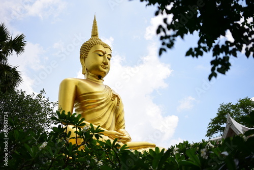 A large golden Buddha statue at a temple in Khueang Nai District Ubon Ratchathani Province, Thailand is revered by Buddhists.