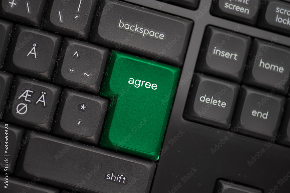 Computer keyboard with a green agree button. Computer keyboard with a green agree button.