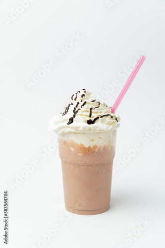 Vertical shot of a chocolate milkshake with a lot of whipped cream on top.