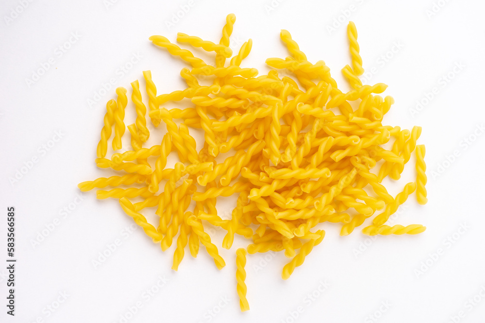 a heap of fusilli pasta isolated on white