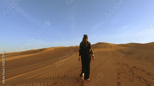 Beautiful woman in brilliant Burqa mask among the Dubai desert at sunset timeArabian style.2,7K