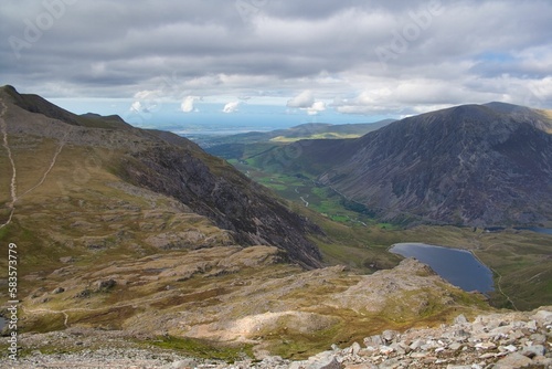 Aerial view of the Ogwen Valley in between a mountain range, in Snowdon in Wales, on a cloudy day