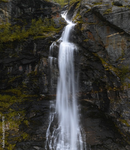 Vertical shot of a flowing waterfall © Jamo Images/Wirestock Creators