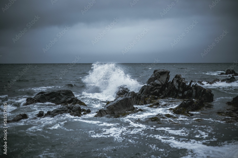 Waves of the ocean crashing into the rocks and splashing