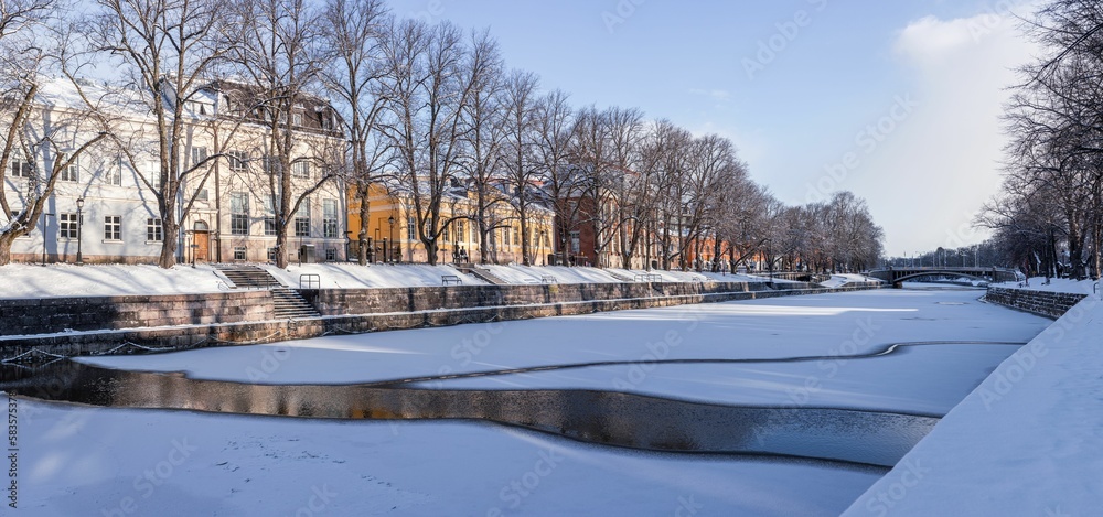 Fototapeta premium Chilling view of a frozen river in the town of Turku in Finland during winter