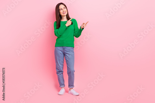 Full length portrait of cheerful nice person look direct fingers empty space isolated on pink color background