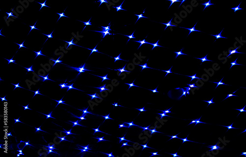 Dark blue lights bokeh on the ceiling of a building in the night. Abstract background for design.