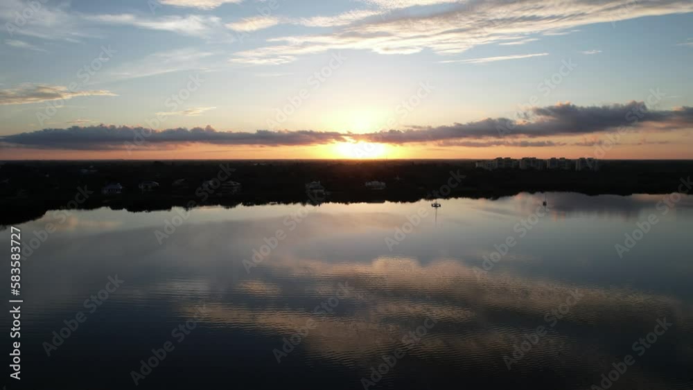 Aerial view of lake surrounded by trees and buildings in Vamo Florida during sunset Aerial view of lake surrounded by trees and buildings in Vamo Florida during sunset