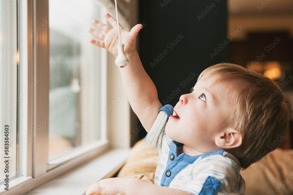 Curious Child Reaches For Window Blind Cord Stock Photo Adobe Stock