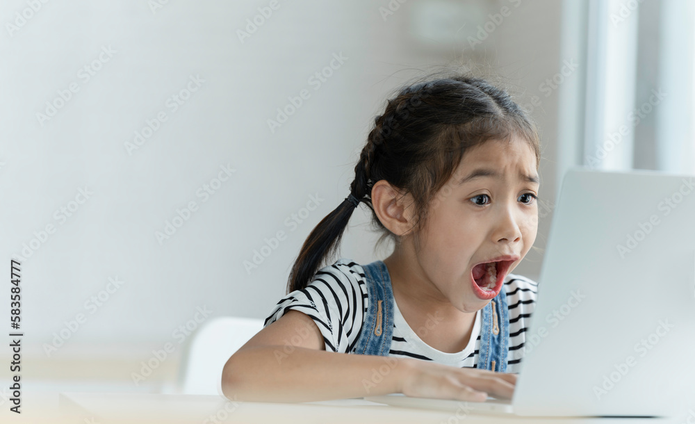 A girl is using a laptop computer, learning for new generations of children. A girl is using a laptop computer, learning for new generations of children.