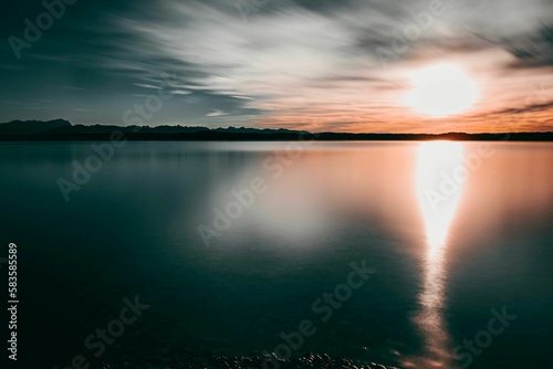 Long exposure of a seascape at the sunset, and reflection of the sunlight in the water