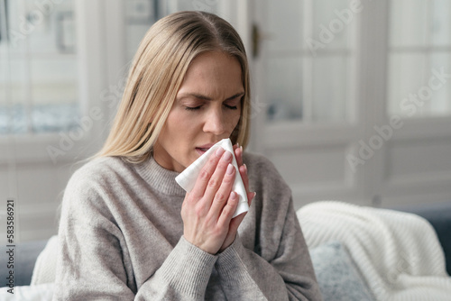 illness woman has respiratory infection and runny nose photo